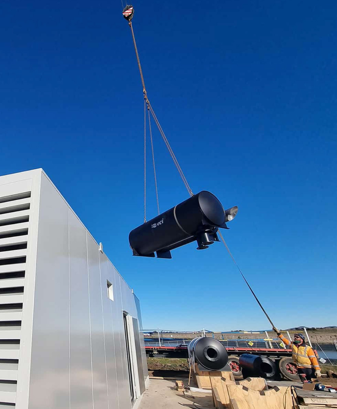 ECI silencer being craned into position beside a containerised plantroom